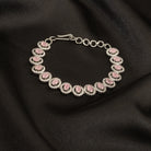 "Delicate pink zircon bracelet in silver, exuding vibrant charm with its soft, rosy glow for party wear."
