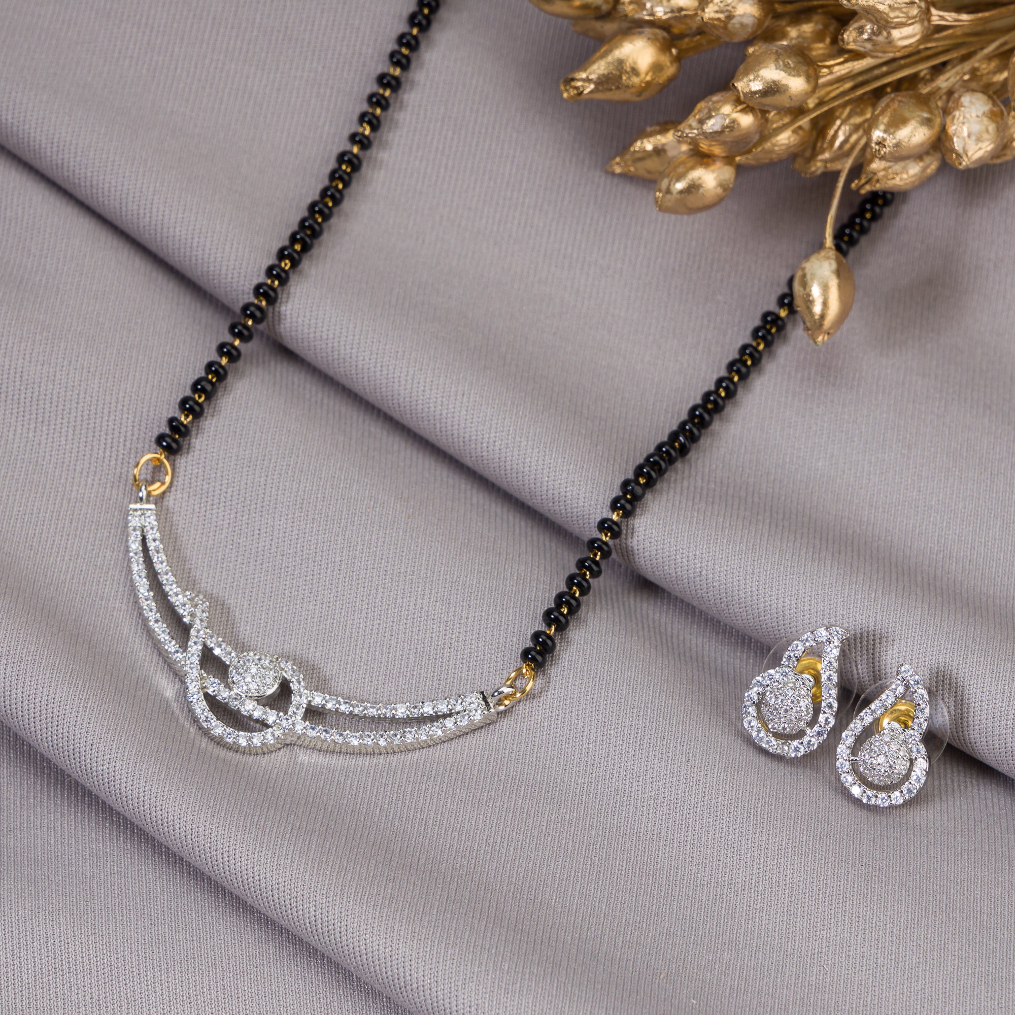 "Black zircon mangalsutra in gold, blending traditional charm with radiant, modern sparkle."
