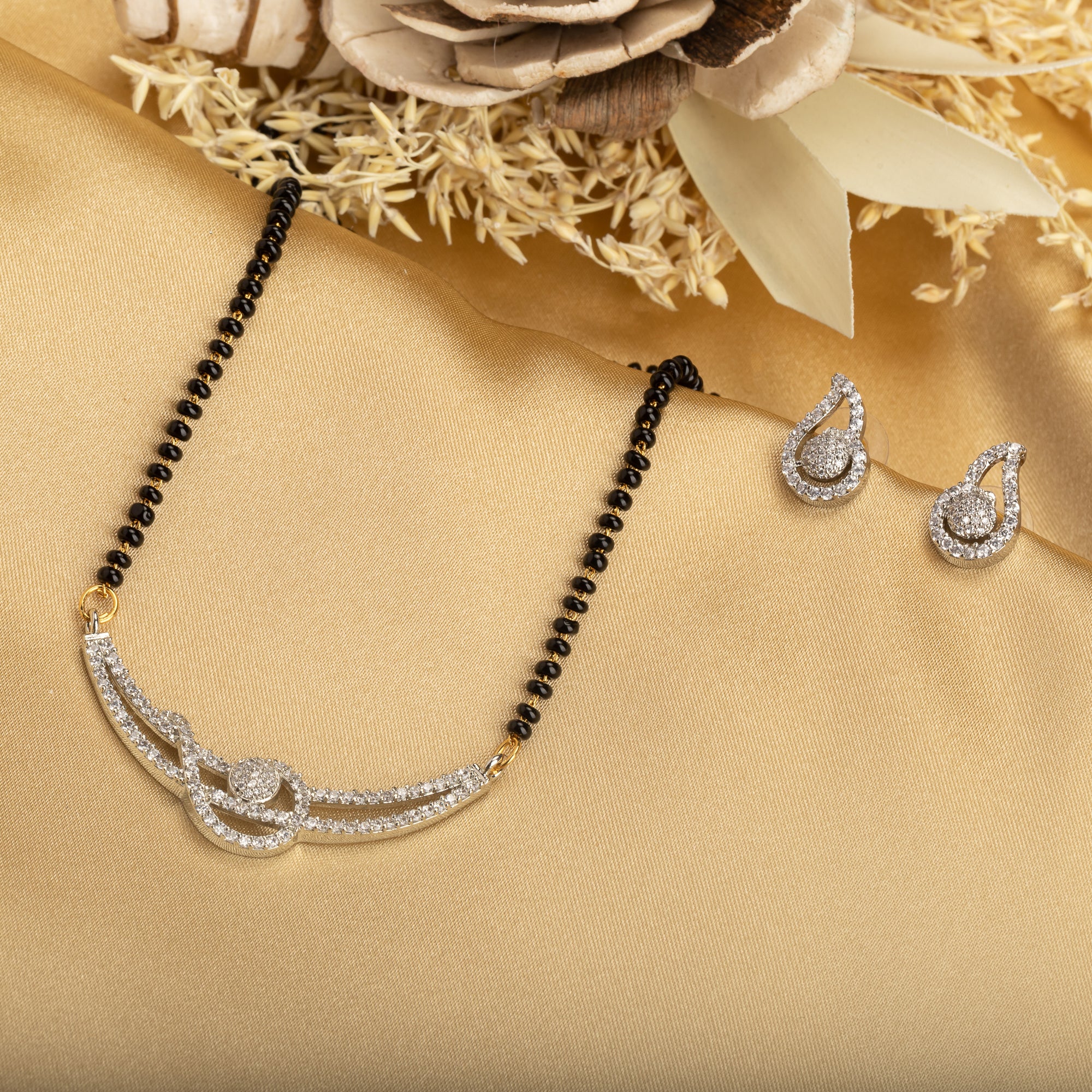 "Black zircon mangalsutra in gold, blending traditional charm with radiant, modern sparkle."
