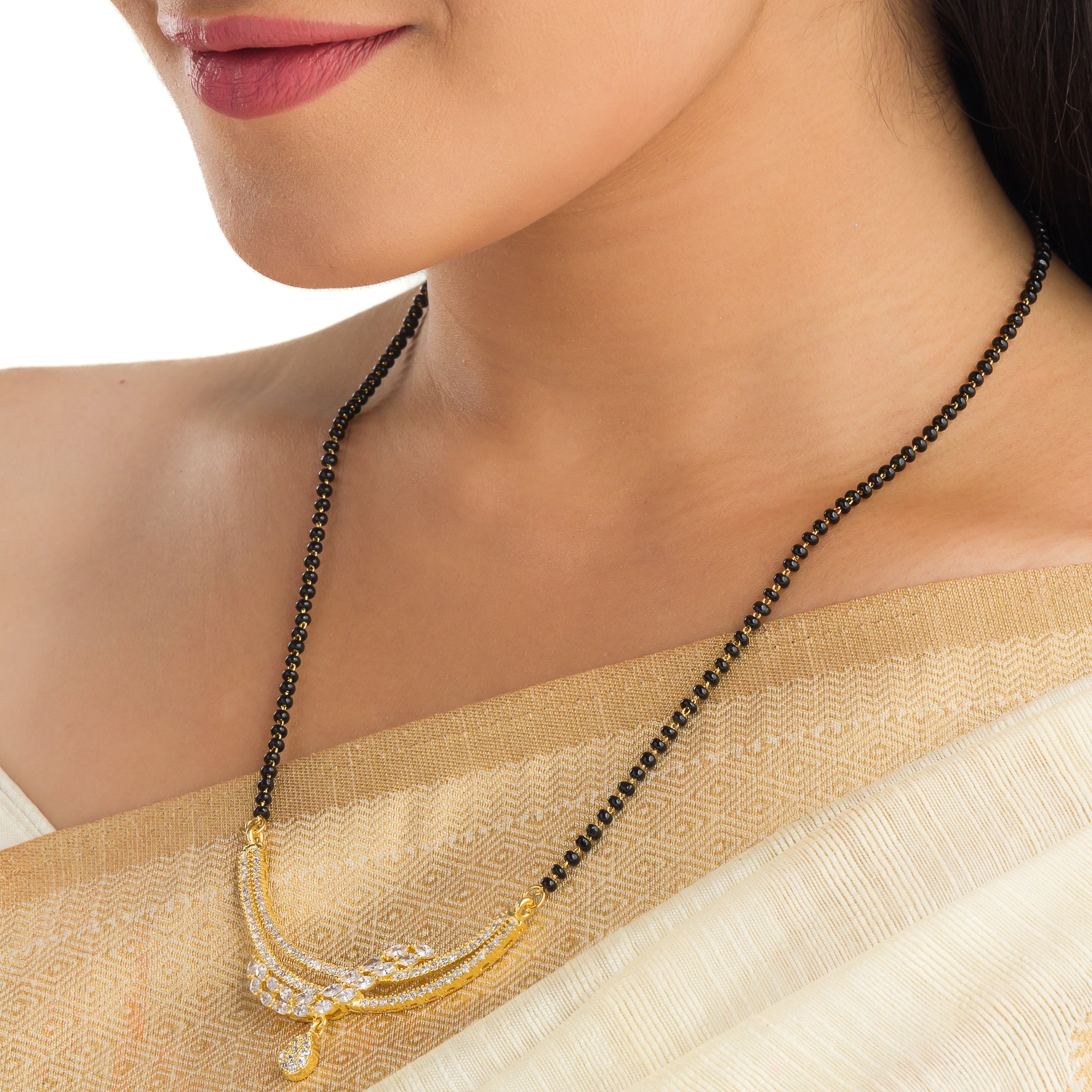 "Zircon mangalsutra in black and gold, combining traditional elegance with modern radiant sparkle."
