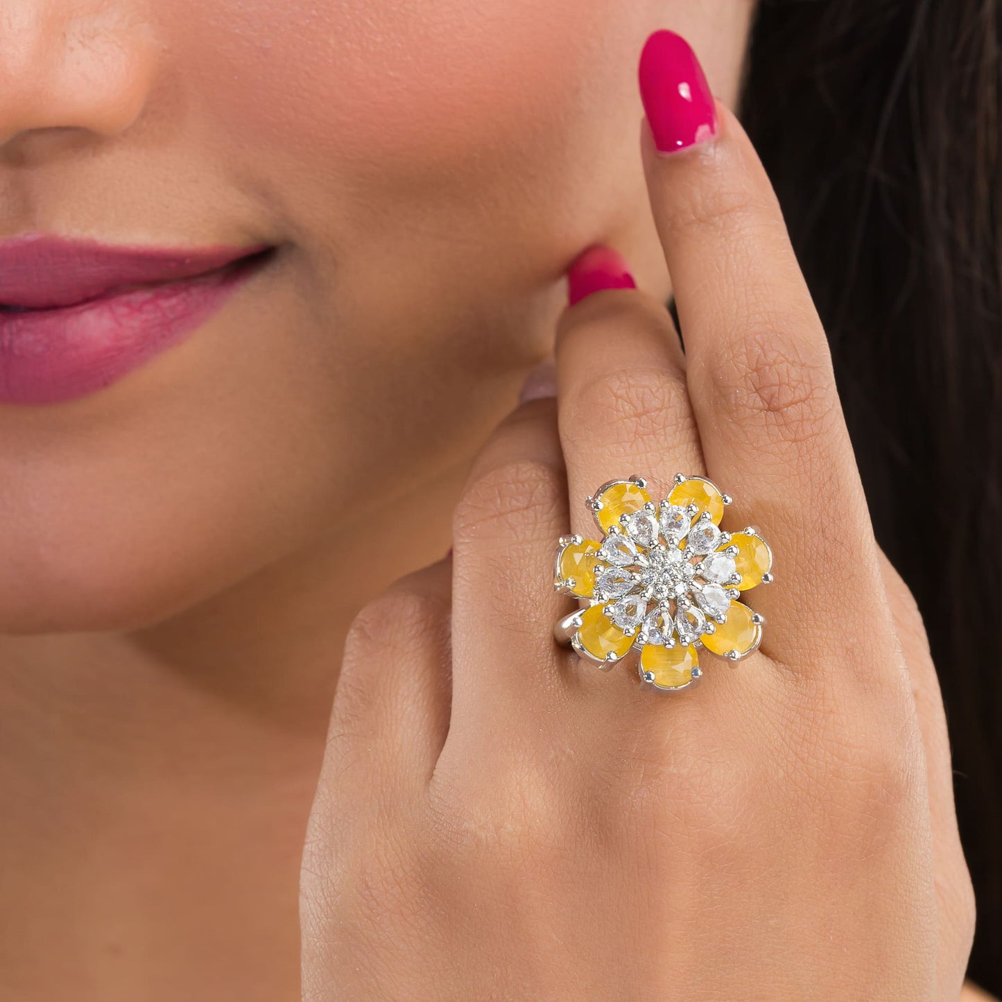 A YELLOW ZIRCON FINGER RING RADIATES VIBRANT, SUNNY BRILLIANCE WITH ITS WARM, GOLDEN HUE.