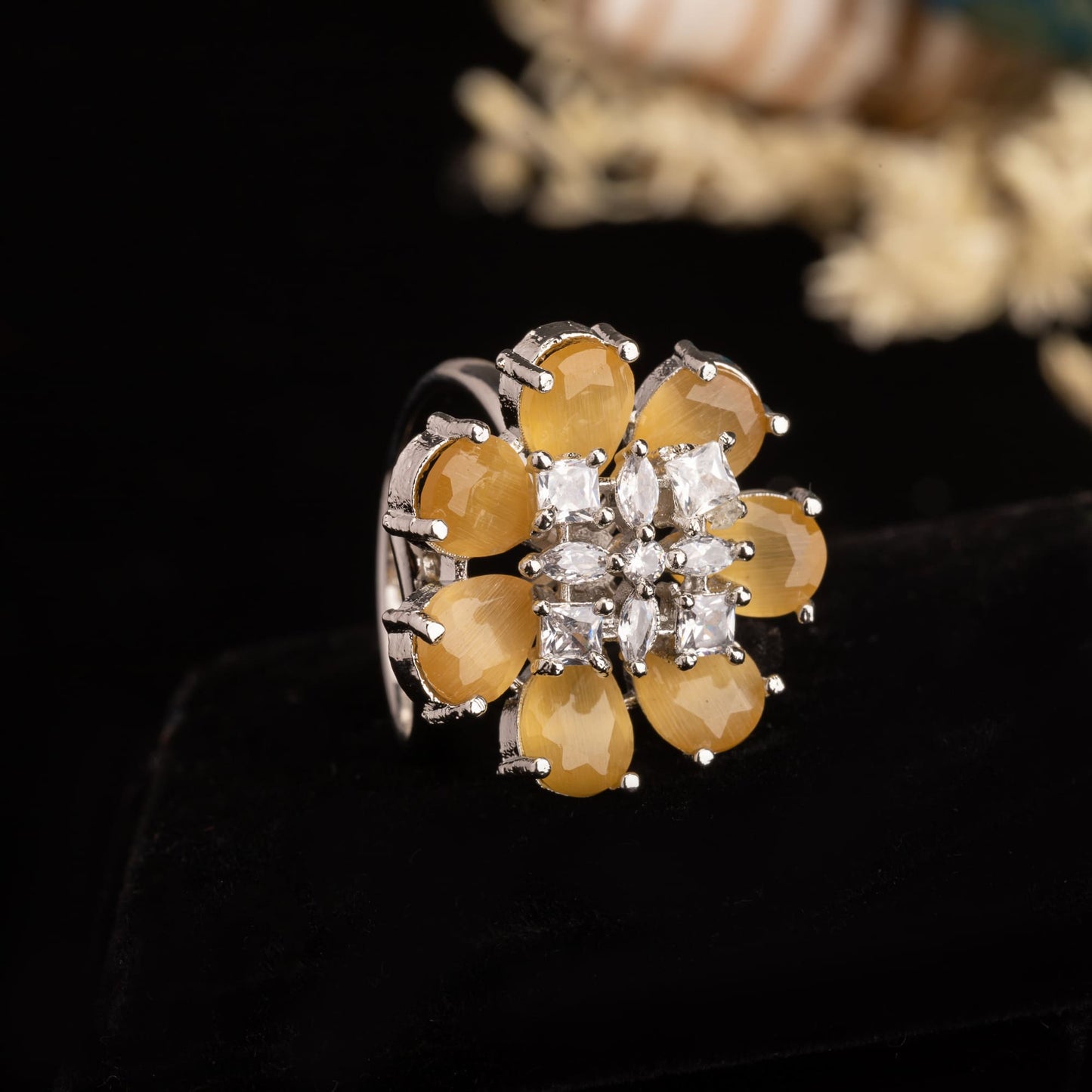 A YELLOW ZIRCON FINGER RING RADIATES VIBRANT, SUNNY BRILLIANCE WITH ITS WARM, GOLDEN HUE.