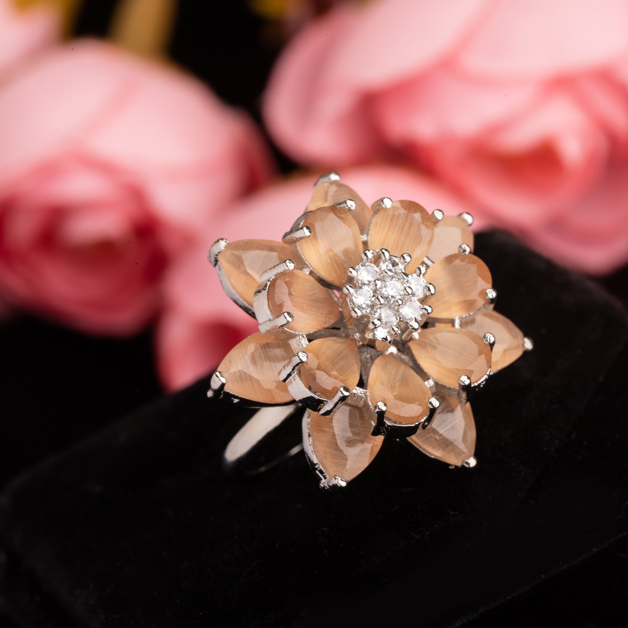 "Salmon zircon finger ring in silver offers a warm, radiant glow with a unique, rosy hue for party wear."
