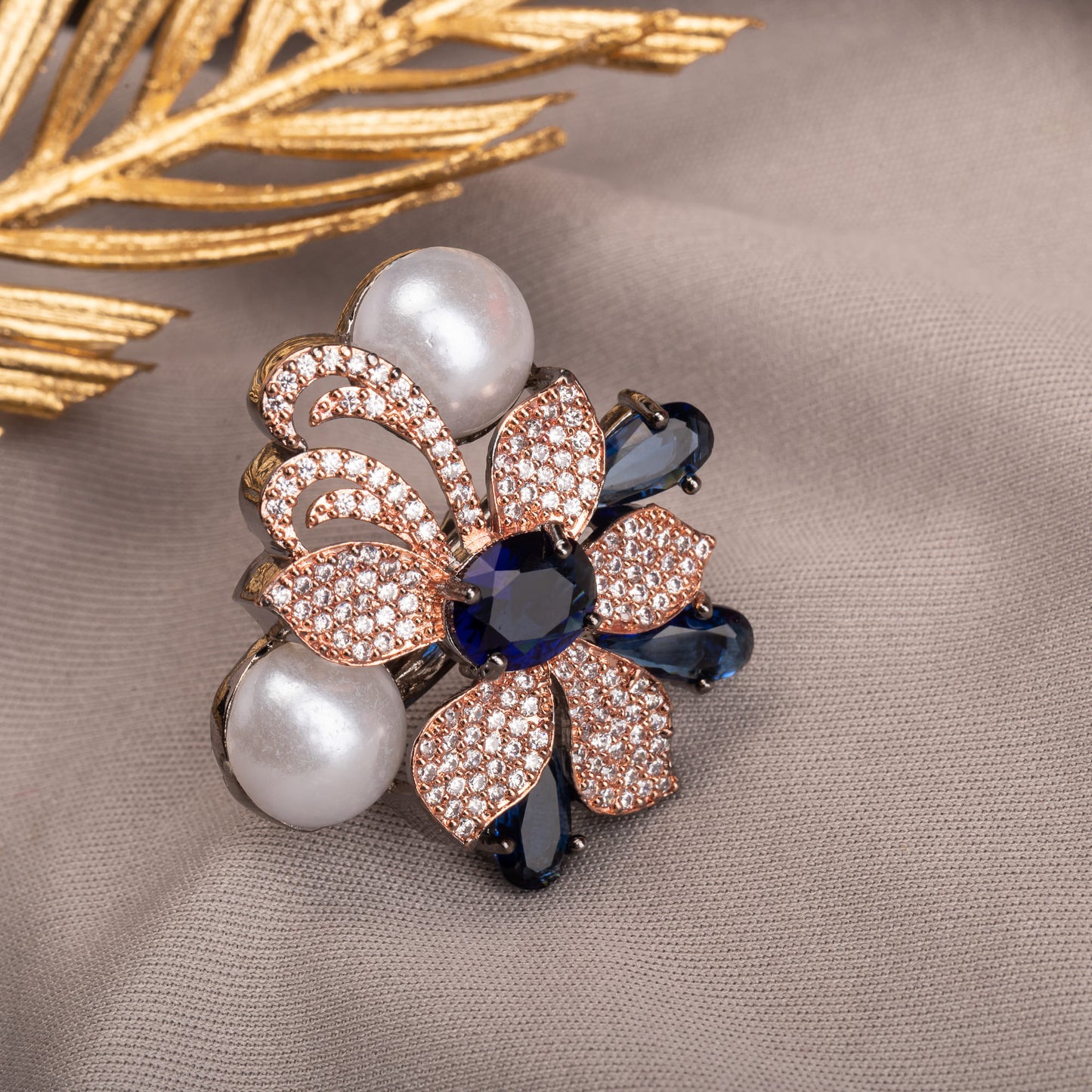 WHITE PEARL AND BLUE ZIRCON STONES WITH ROSE GOLD POLISH BLEND CLASSIC ELEGANCE WITH A MODERN, VIBRANT TOUCH.