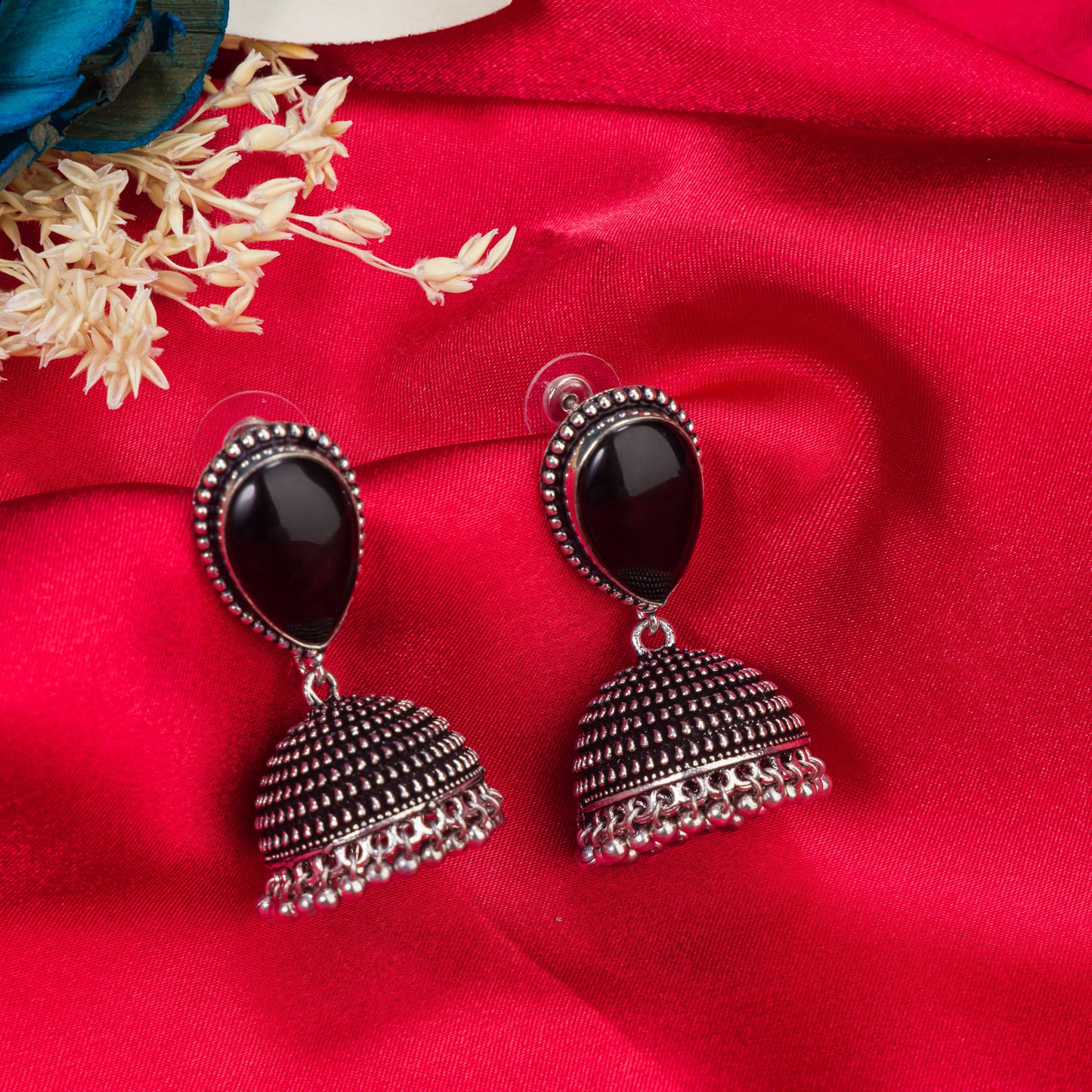 "OXIDIZED JHUMKA WITH A BLACK STONE AT THE CENTER DELIVERS A STRIKING, VINTAGE ALLURE."