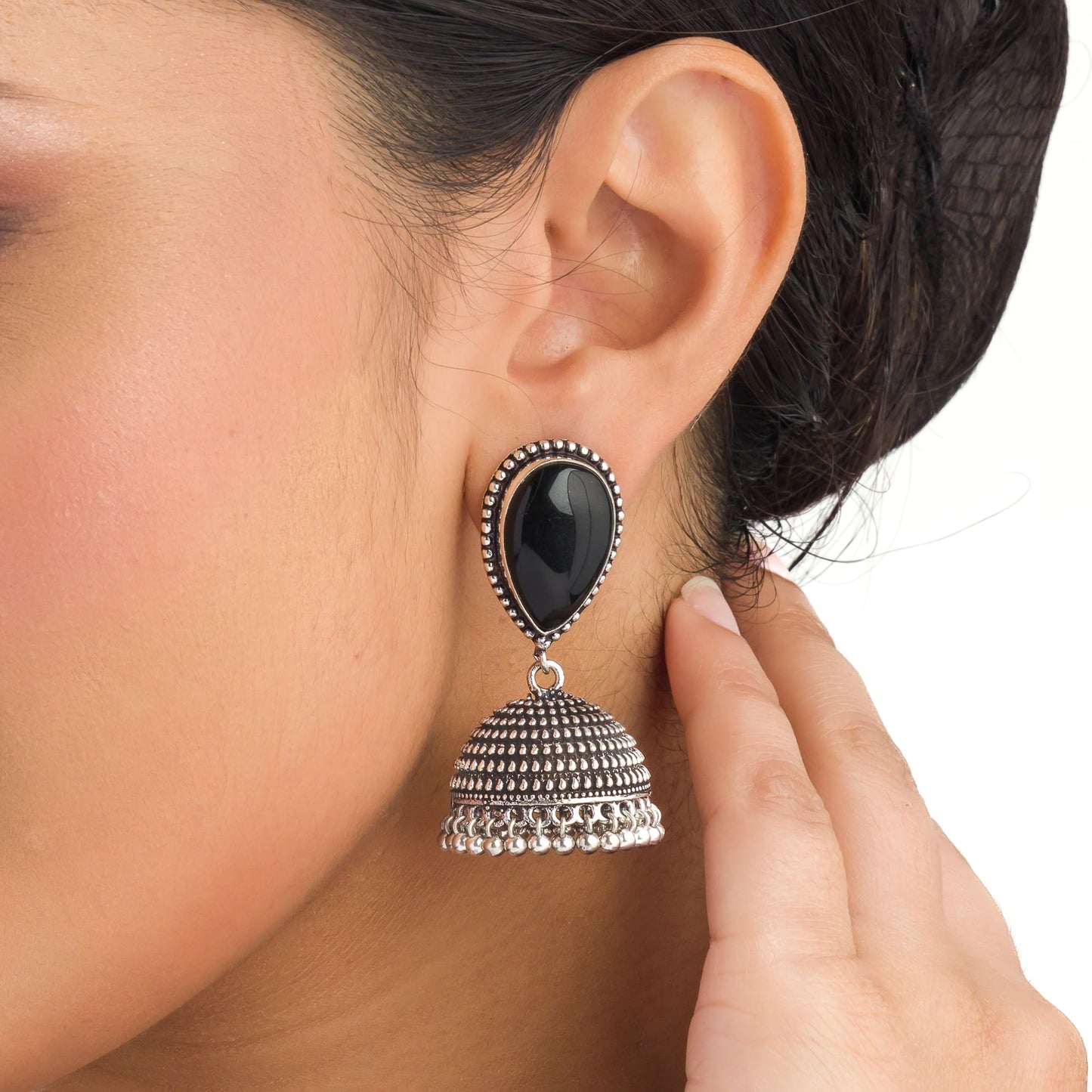 "OXIDIZED JHUMKA WITH A BLACK STONE AT THE CENTER DELIVERS A STRIKING, VINTAGE ALLURE."