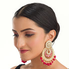  "Red kundan dangler earrings in gold add a vibrant touch to your festive look. Perfect for celebrations."
