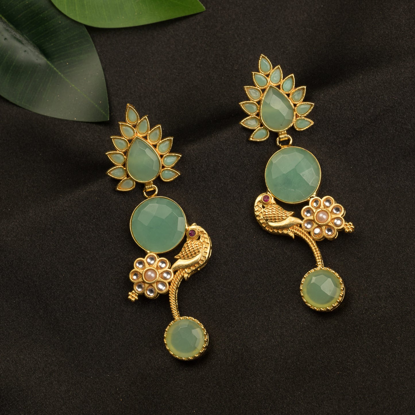 "GOLD-TONE EARRINGS WITH LIGHT GREEN ACCENTS BLEND WARMTH AND FRESHNESS FOR A CHIC, EYE-CATCHING LOOK."