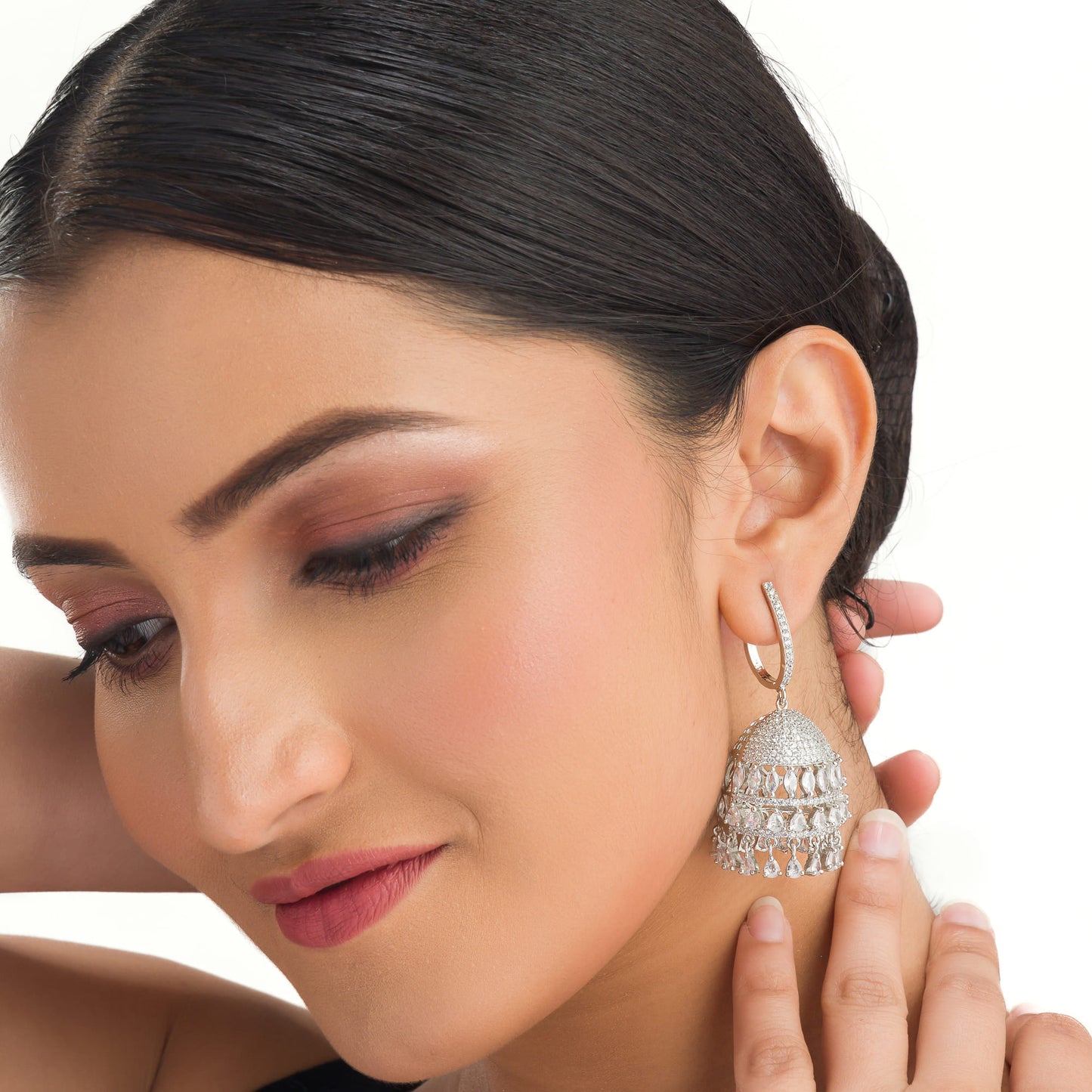 "ZIRCON JHUMKA COMBINES INTRICATE DETAILING WITH RADIANT SPARKLE FOR A STUNNING, TRADITIONAL TOUCH."