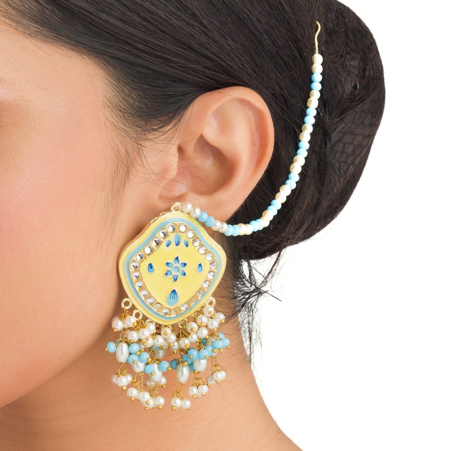 "WHEAT-COLORED EARRINGS AND MAANGTIKA, ADORNED WITH AQUA AND WHITE PEARL BEADS, OFFER A GRACEFUL BLEND OF SUBTLE ELEGANCE AND VIBRANT CHARM."