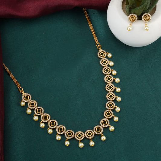 THIS NECKLACE SET FEATURES A NECKLACE AND MATCHING EARRINGS ADORNED WITH SPARKLING ZIRCON STONES.