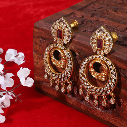 ENHANCE YOUR ELEGANCE WITH THESE ZIRCON STONES STUDDED GOLDTONE EARRINGS.