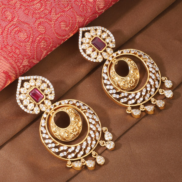 ENHANCE YOUR ELEGANCE WITH THESE ZIRCON STONES STUDDED GOLDTONE EARRINGS.