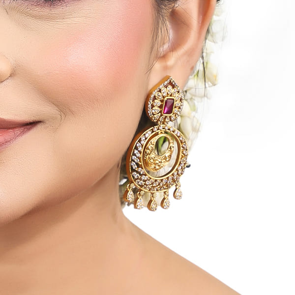 ENHANCE YOUR ELEGANCE WITH THESE ZIRCON STONES STUDDED GOLDTONE EARRINGS.