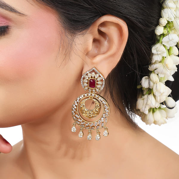 ENHANCE YOUR ELEGANCE WITH THESE ZIRCON STONES STUDDED GOLDTONE EARRINGS.