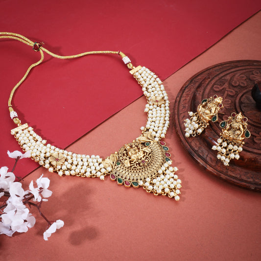 THE LAXMI MAA CRAFTED GOLD-TONE NECKLACE SET WITH WHITE PEARLS COMBINES DIVINE CRAFTSMANSHIP WITH ELEGANT DESIGN.