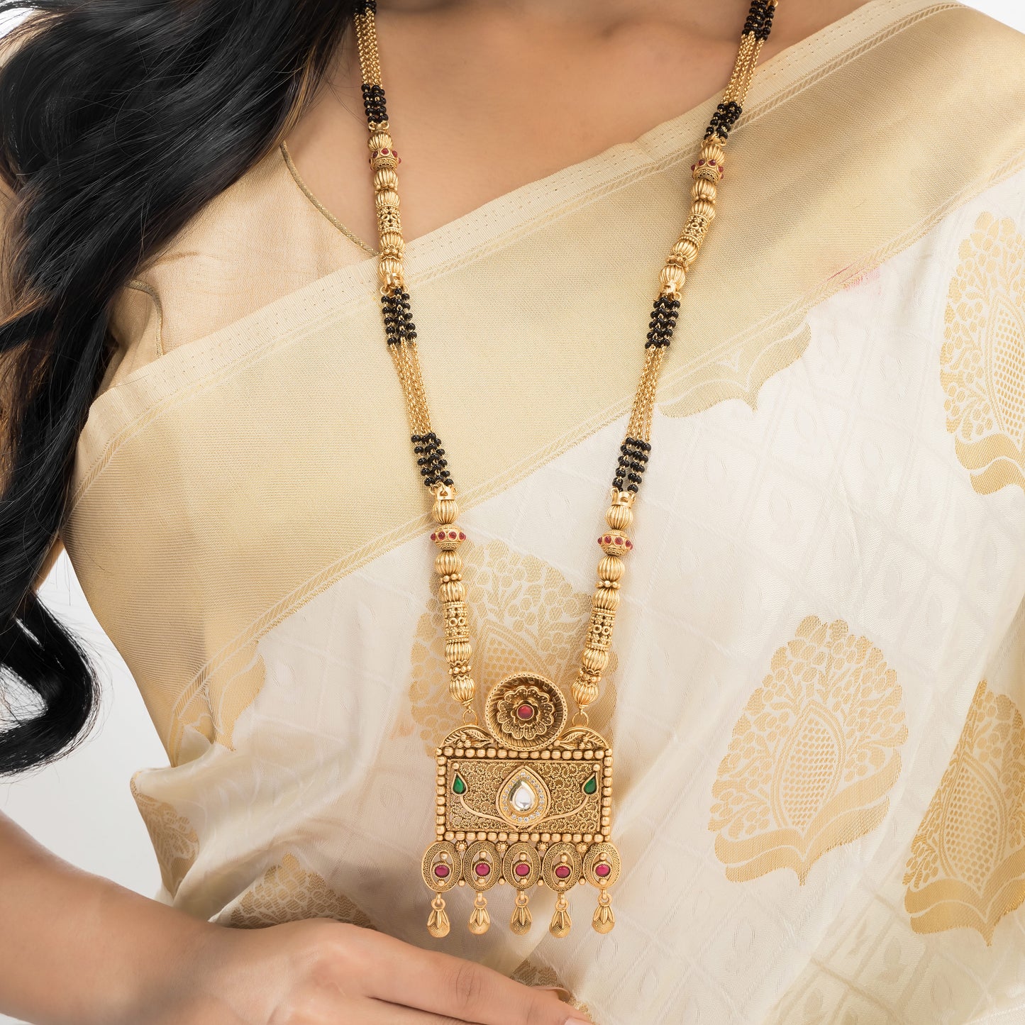 LONG GOLD-TONE MANGALSUTRA WITH BLACK BEADS AND STONES STUDDED.