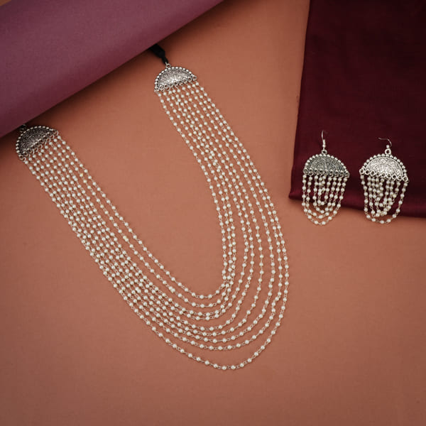 ADD ELEGANCE WITH THIS PEARLS STUDDED LAYERED DESIGN OXIDIZED LONG NECKLACE SET. WITH MATCHING EARRINGS