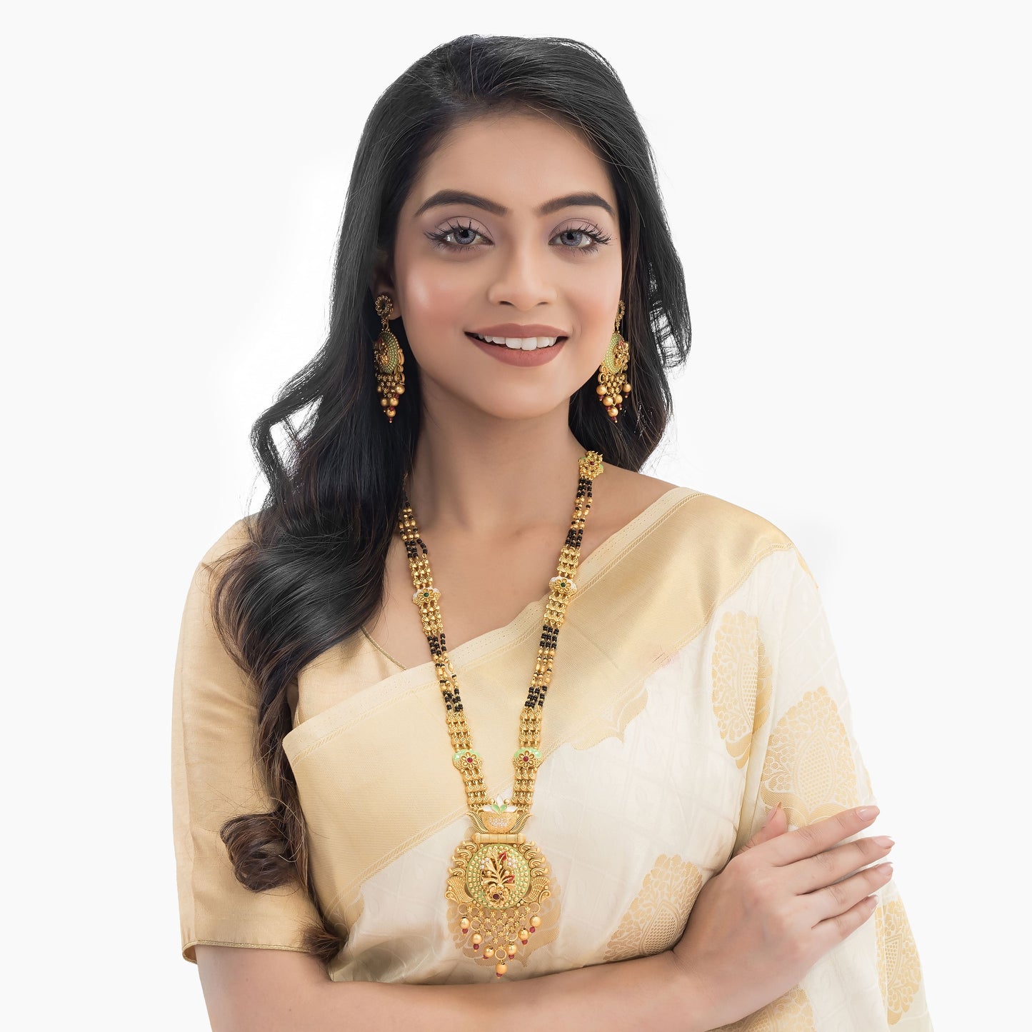 FLORAL DESIGN STUDDED GOLD-TONE MANGALSUTRA WITH BLACK BEADS AND MATCHING EARRINGS.