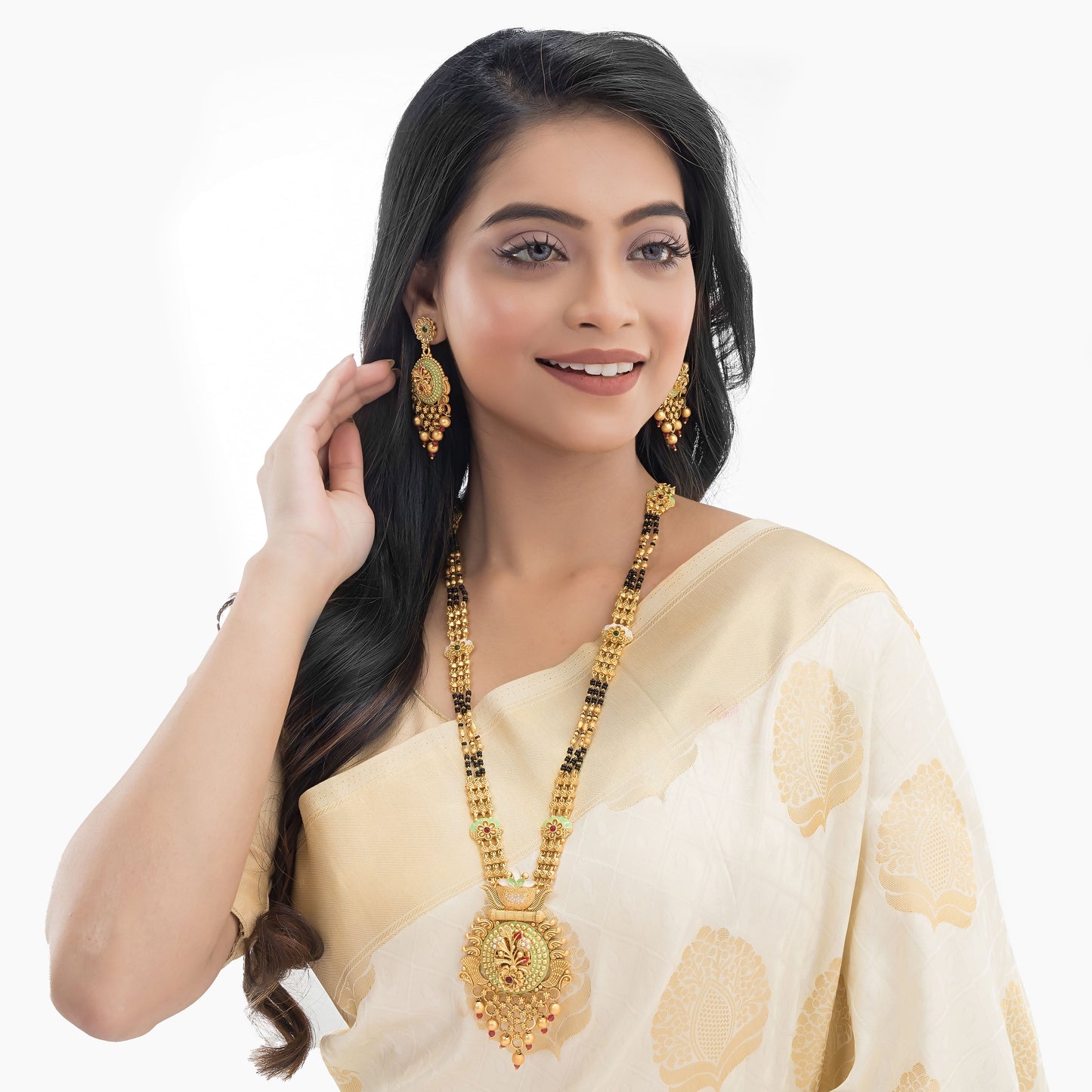 FLORAL DESIGN STUDDED GOLD-TONE MANGALSUTRA WITH BLACK BEADS AND MATCHING EARRINGS.