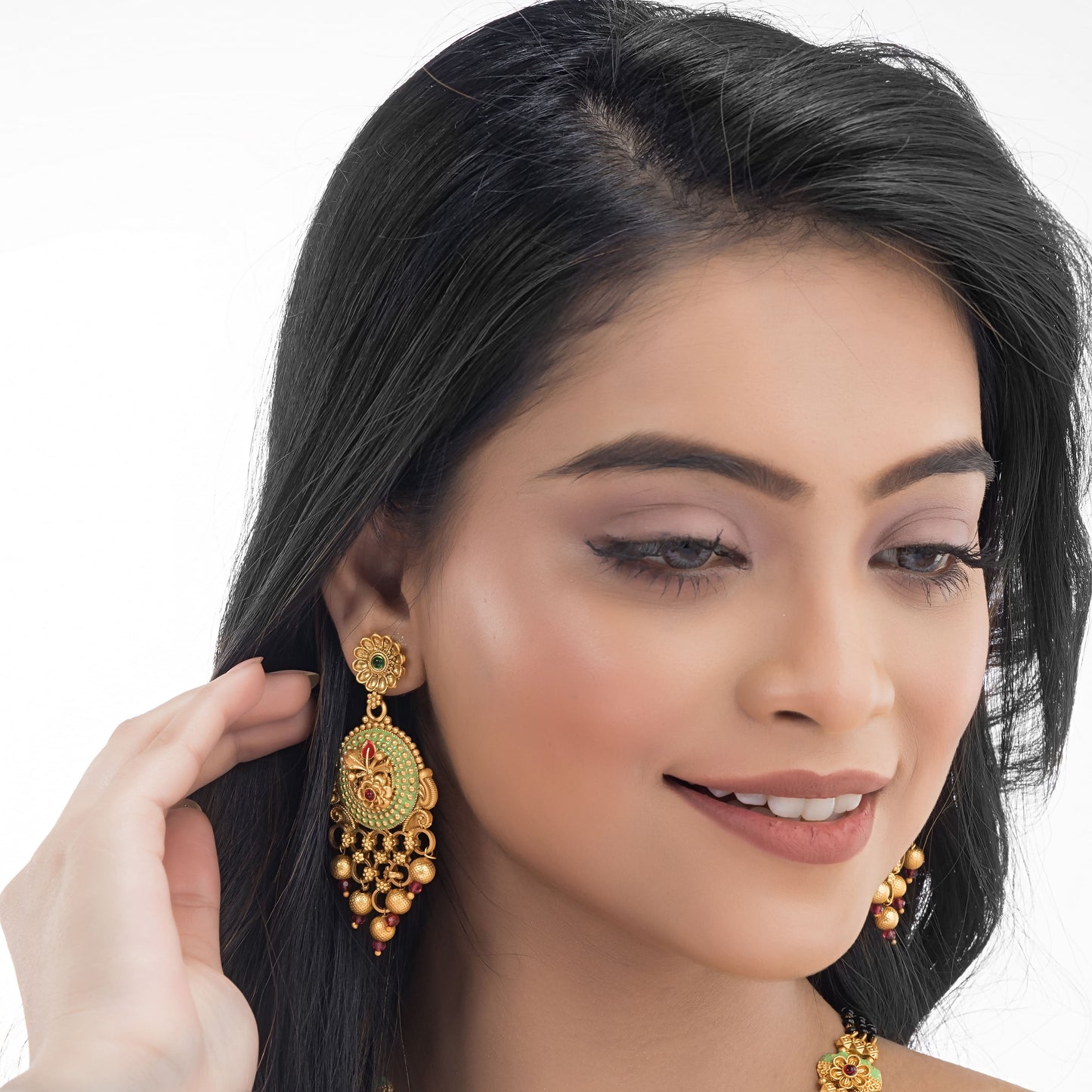 FLORAL DESIGN STUDDED GOLD-TONE MANGALSUTRA WITH BLACK BEADS AND MATCHING EARRINGS.