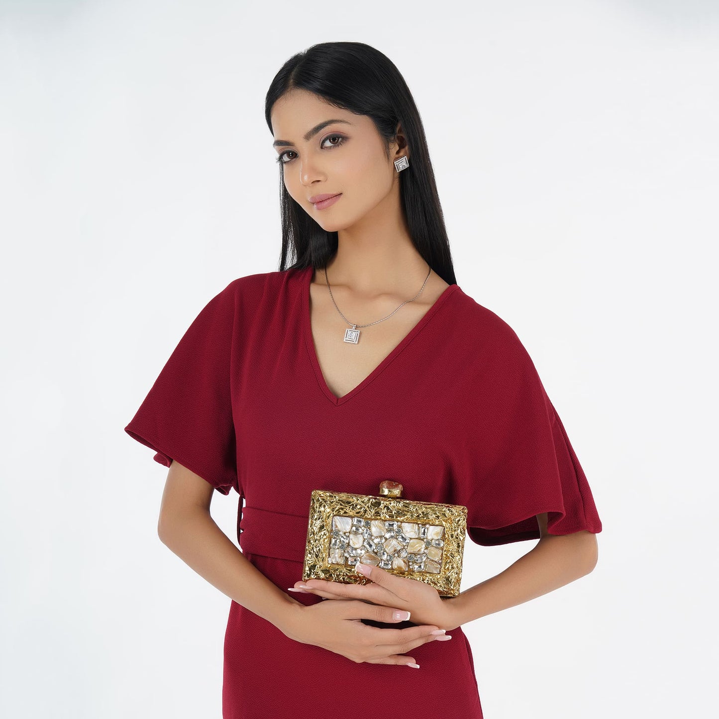 ADD A TOUCH OF LUXURY WITH THIS DESIGNER BRASS MOP CLUTCH, ADORNED WITH SPARKLING ZIRCON STONES.