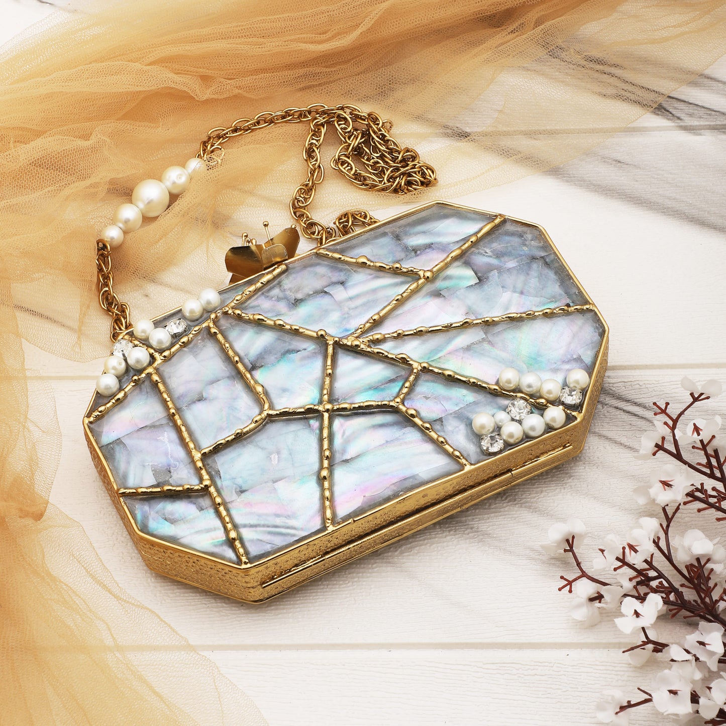 "ELEVATE YOUR STYLE WITH THIS DESIGNER HEXAGONAL-SHAPED MOP CLUTCH.