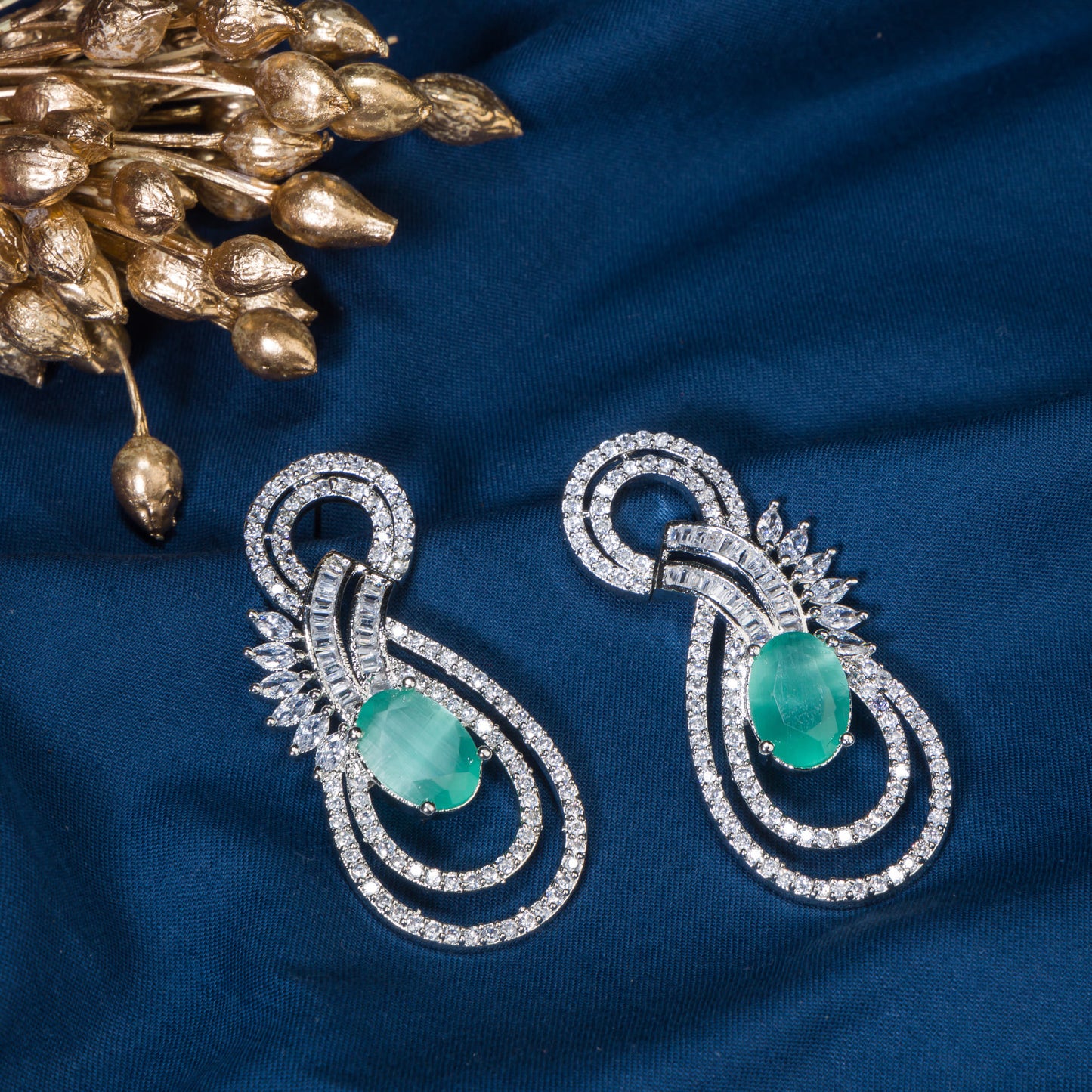 "TURQUOISE ZIRCON EARRINGS OFFER A STUNNING POP OF VIBRANT, OCEANIC COLOR AND ELEGANCE."