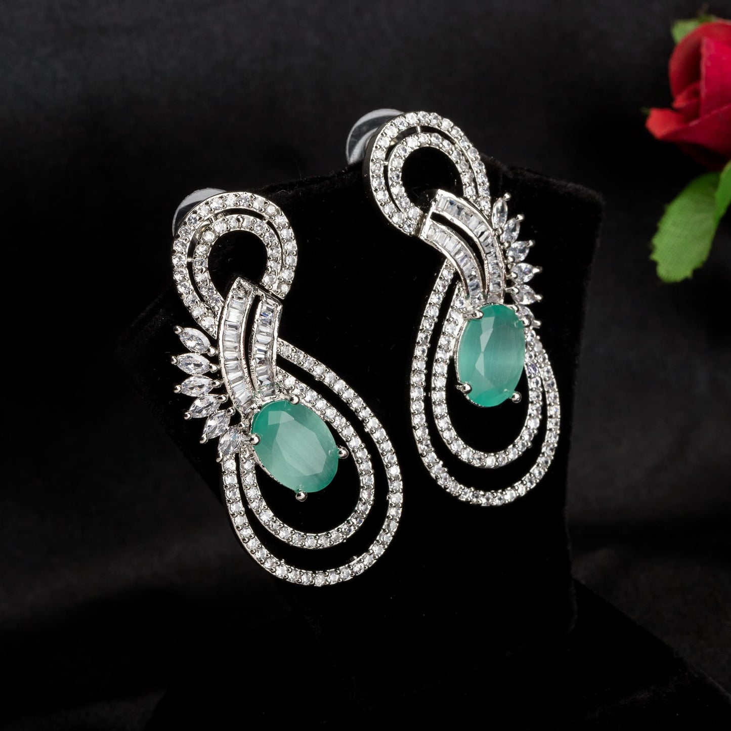 "TURQUOISE ZIRCON EARRINGS OFFER A STUNNING POP OF VIBRANT, OCEANIC COLOR AND ELEGANCE."