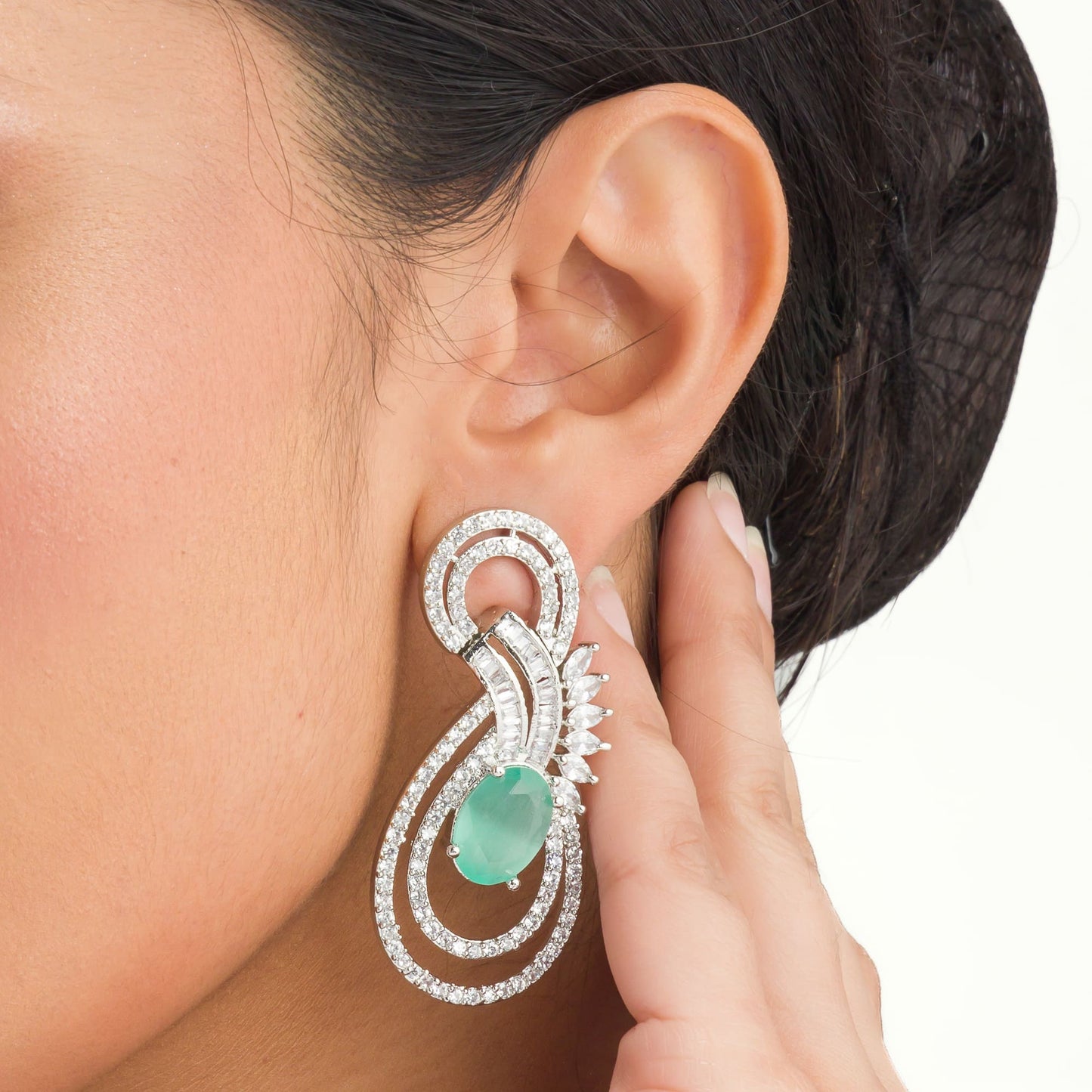 "TURQUOISE ZIRCON EARRINGS OFFER A STUNNING POP OF VIBRANT, OCEANIC COLOR AND ELEGANCE."