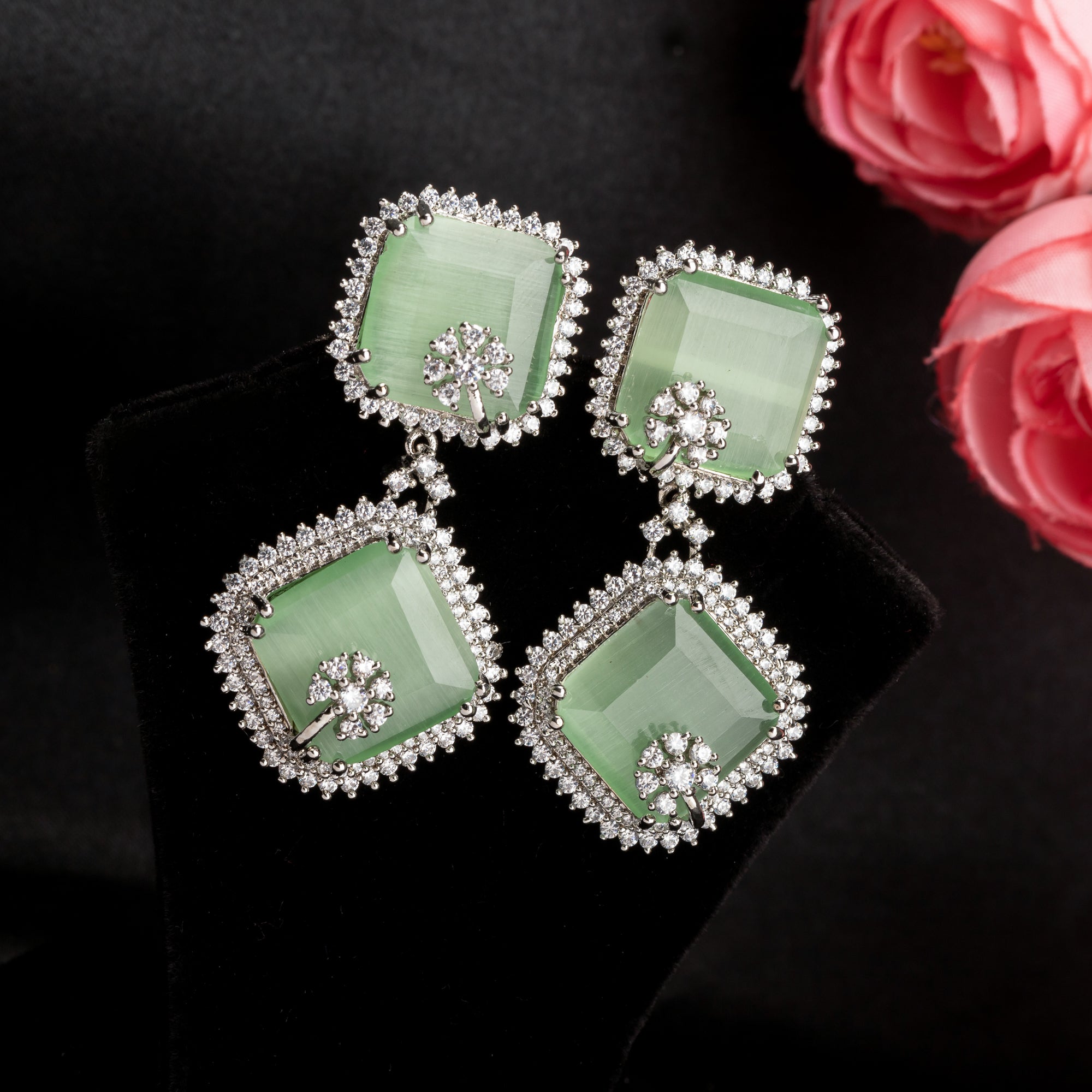 1. "Light green zircon dangler earrings offer delicate sparkle and serene elegance for any occasion."
