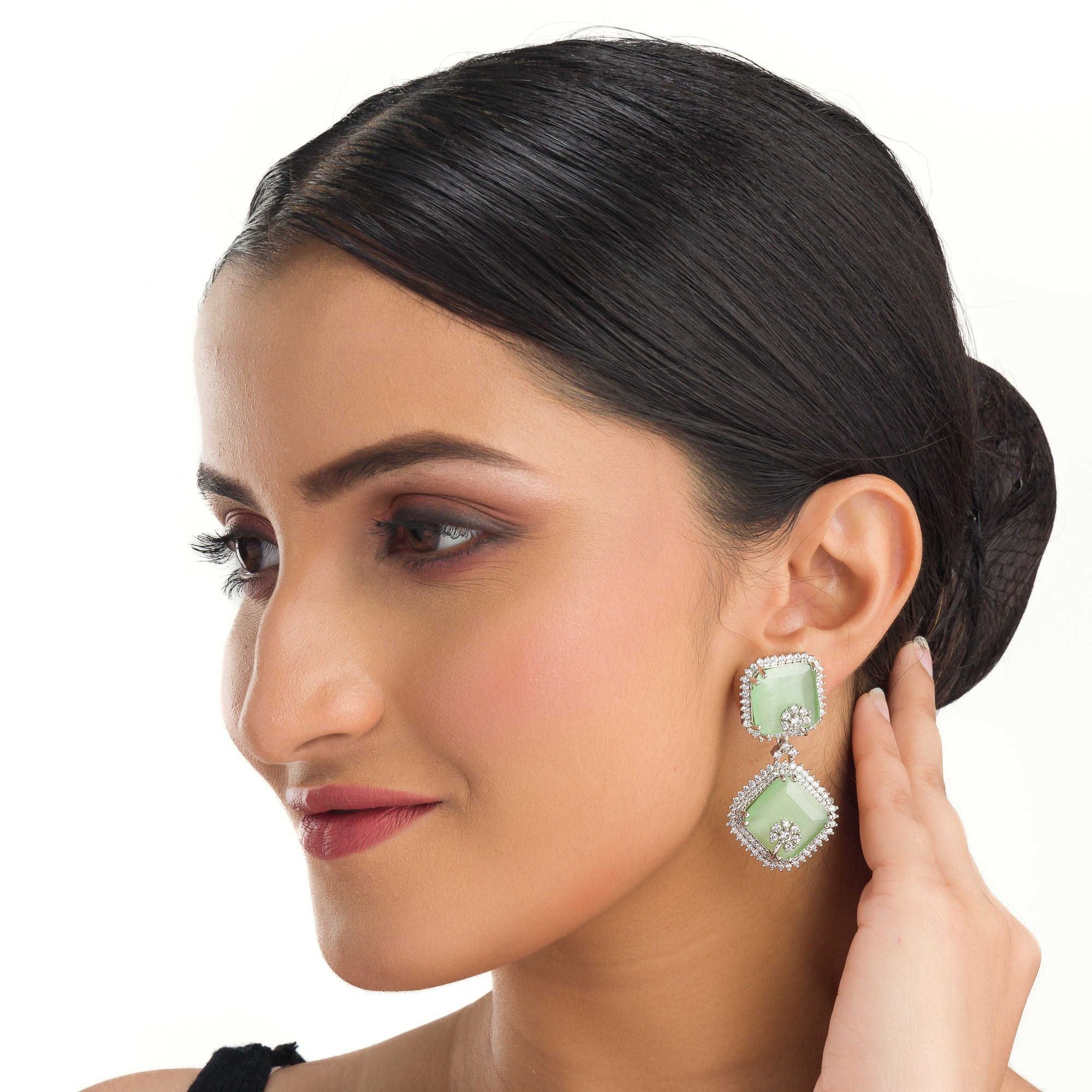 1. "Light green zircon dangler earrings offer delicate sparkle and serene elegance for any occasion."
