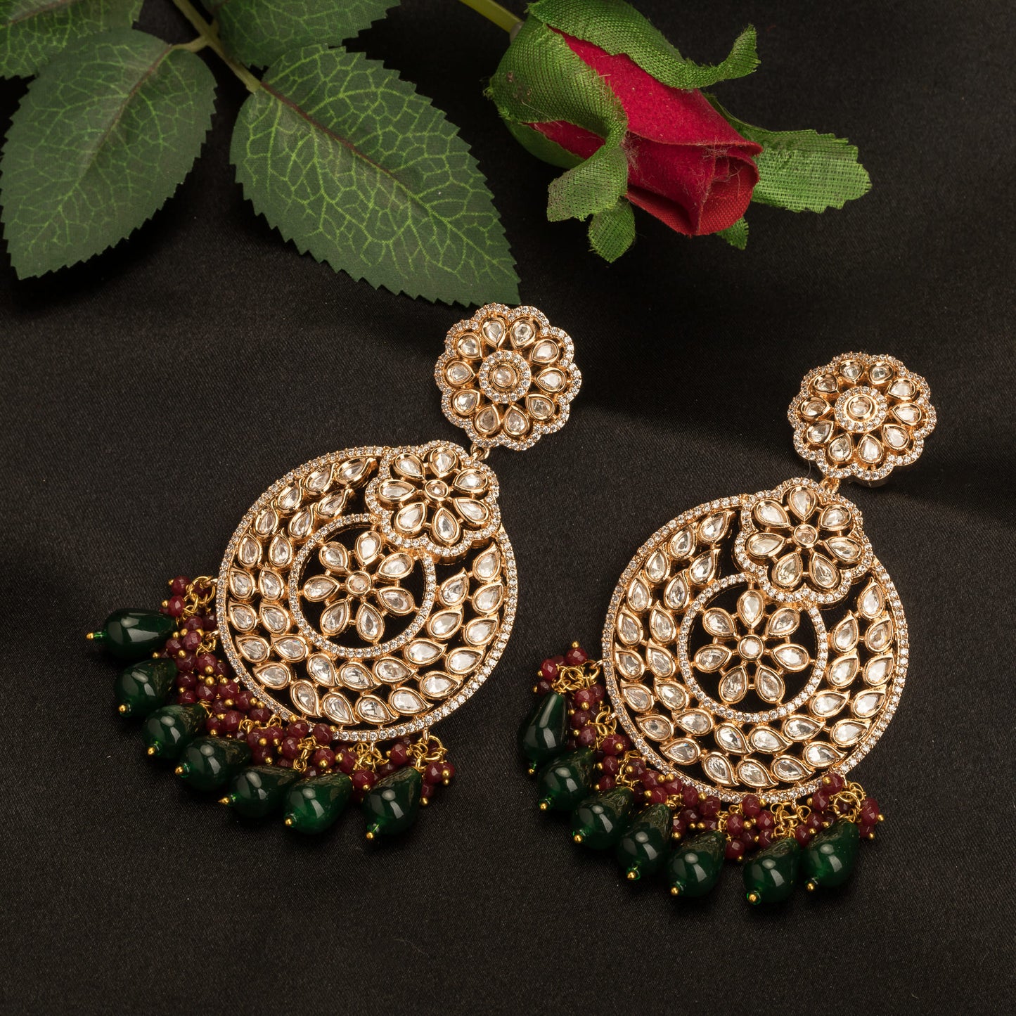 "INTRICATELY DESIGNED KUNDAN EARRINGS RADIATE TIMELESS ELEGANCE AND REGAL CHARM."