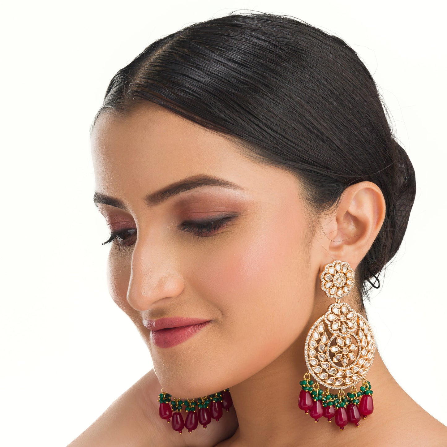 "INTRICATELY DESIGNED KUNDAN EARRINGS RADIATE TIMELESS ELEGANCE AND REGAL CHARM."