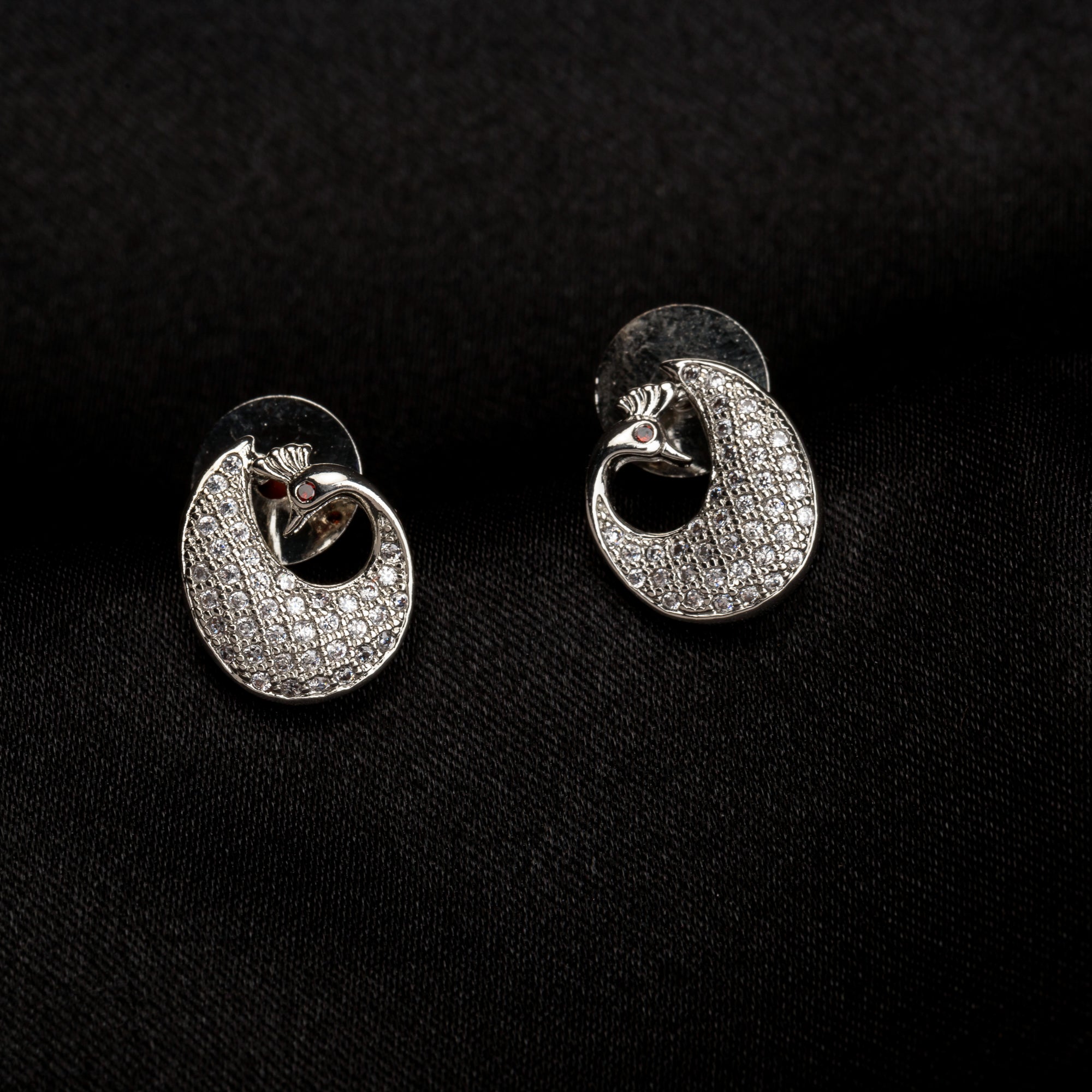 "Elegant peacock-shaped zircon studs add whimsical beauty and sparkle to your look."
