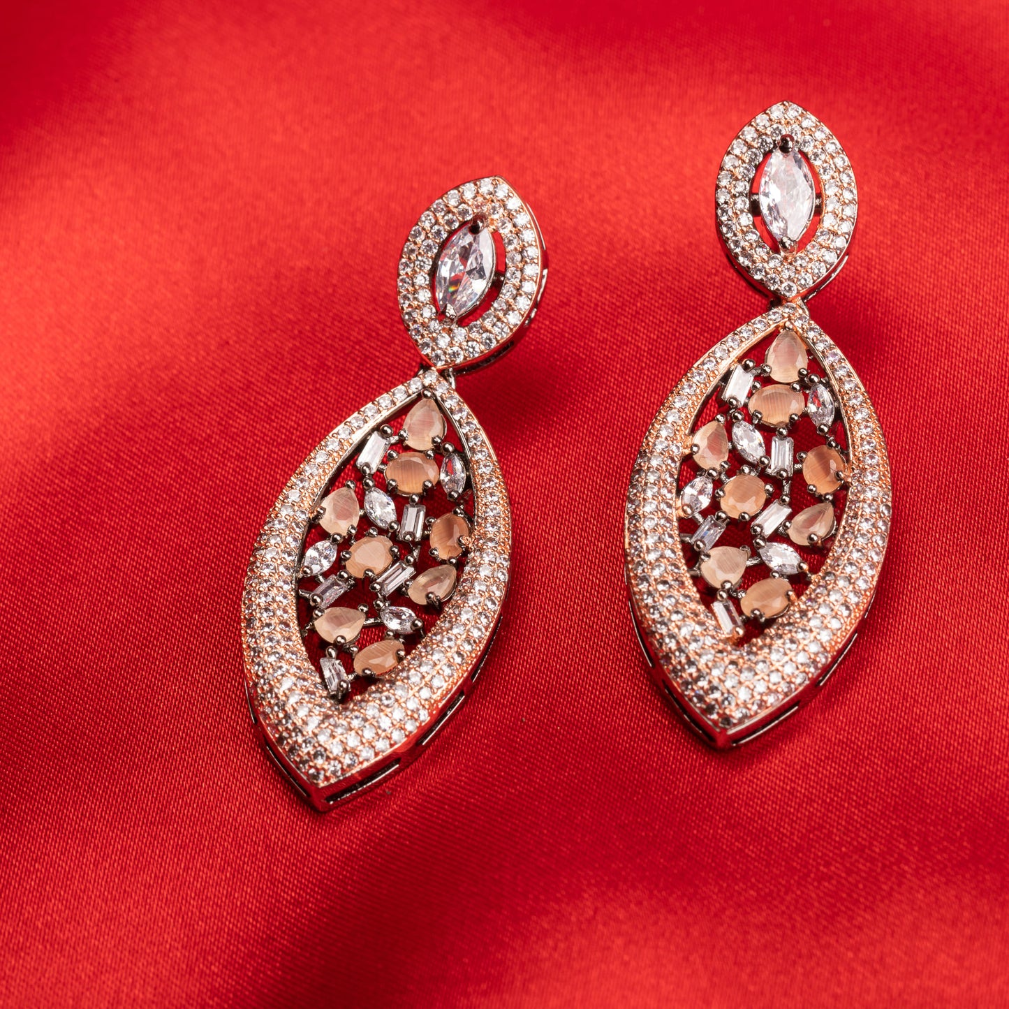 "ROSE GOLD EARRINGS WITH SALMON ZIRCON EXUDE A WARM, RADIANT CHARM THAT'S BOTH SOPHISTICATED AND ENCHANTING."