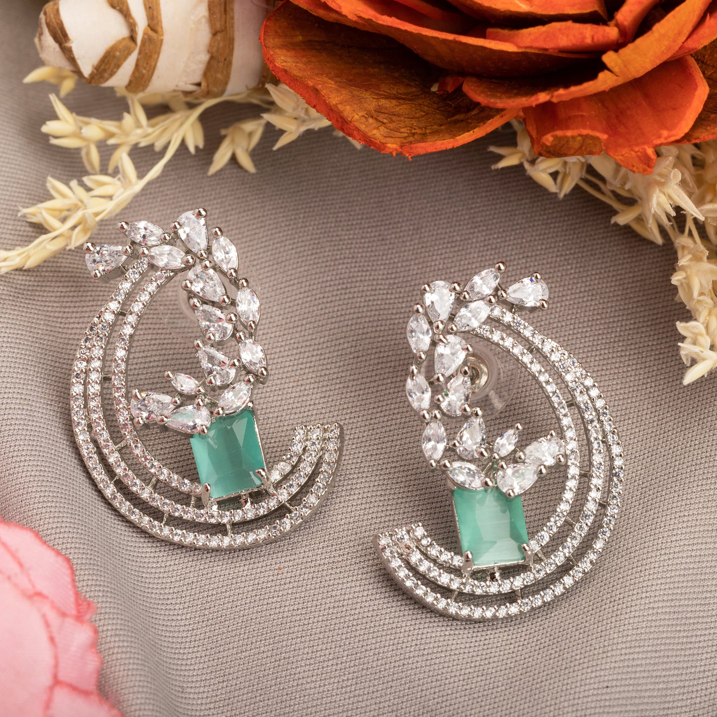 "STUNNING ZIRCON EARRINGS WITH A CAPTIVATING TURQUOISE  HUE ADD A TOUCH OF ELEGANCE AND SPARKLE TO ANY OUTFIT."