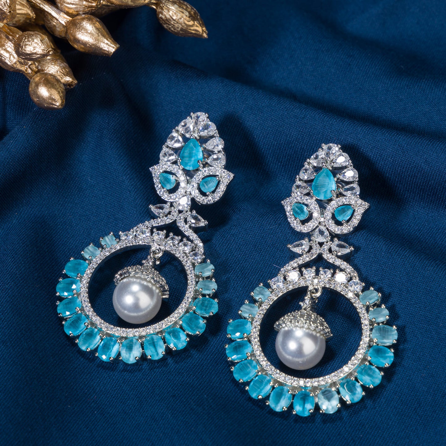 "STUNNING ZIRCON EARRINGS WITH A CAPTIVATING AQUA HUE ADD A TOUCH OF ELEGANCE AND SPARKLE TO ANY OUTFIT."