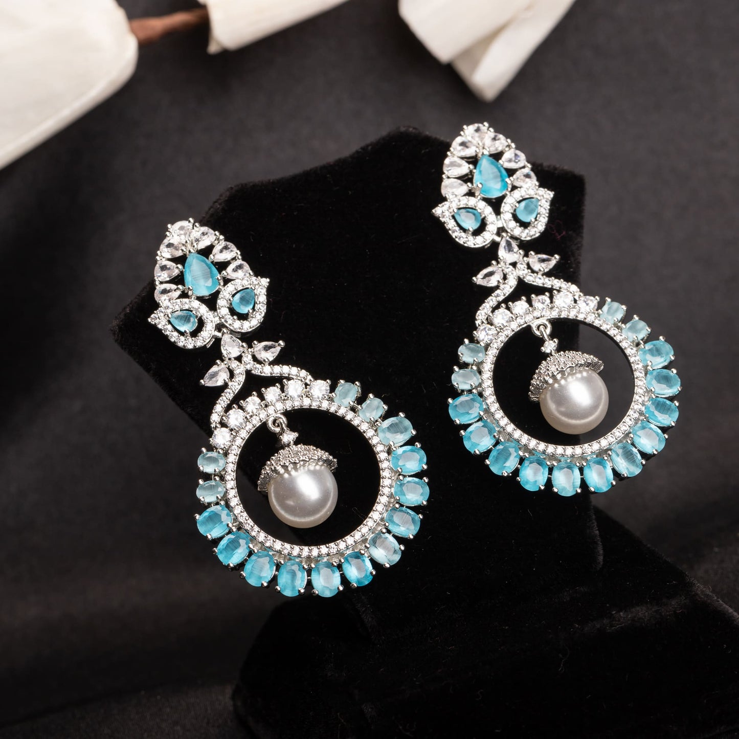 "STUNNING ZIRCON EARRINGS WITH A CAPTIVATING AQUA HUE ADD A TOUCH OF ELEGANCE AND SPARKLE TO ANY OUTFIT."