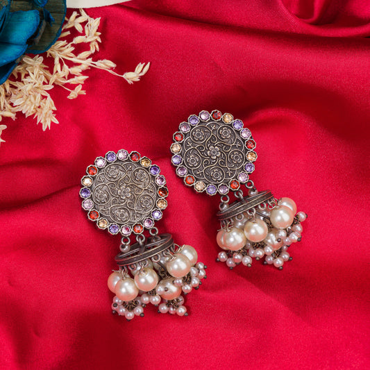 "OXIDIZED EARRINGS WITH MULTI-COLOR STONES AND PEARLS ADD A VIBRANT, BOHEMIAN TOUCH."