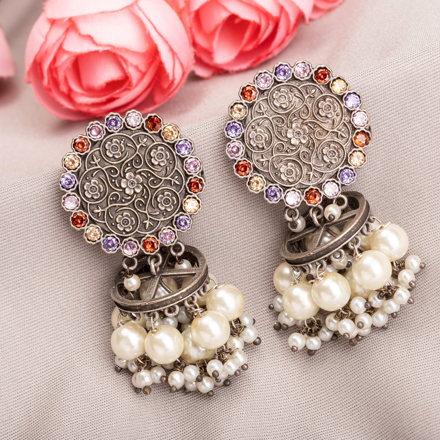 "OXIDIZED EARRINGS WITH MULTI-COLOR STONES AND PEARLS ADD A VIBRANT, BOHEMIAN TOUCH."