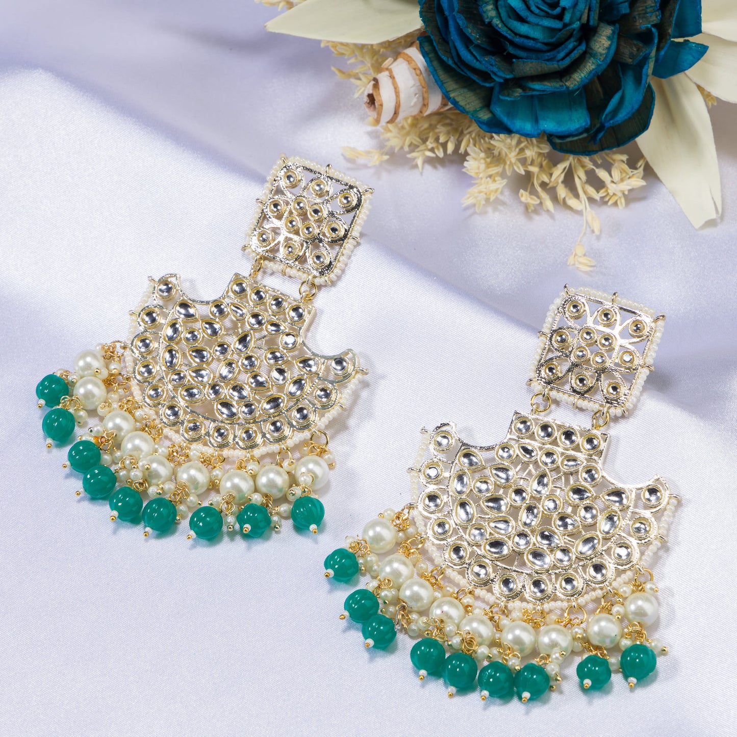 "KUNDAN EARRING SET WITH GREEN AND WHITE PEARLS OFFERS A REGAL, TIMELESS ALLURE."