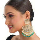 1. "Kundan channbali earrings with green and white pearls offer a regal, timeless allure."
