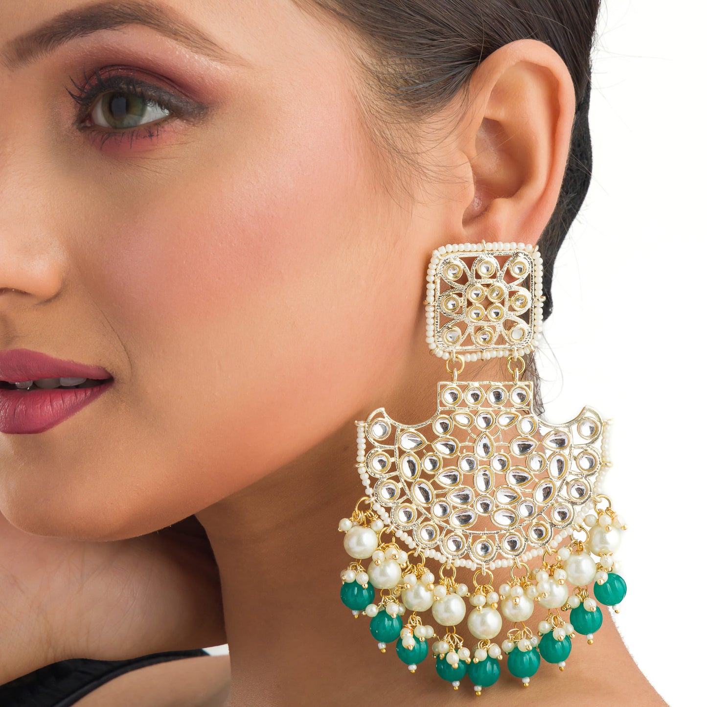 "KUNDAN EARRING SET WITH GREEN AND WHITE PEARLS OFFERS A REGAL, TIMELESS ALLURE."