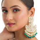 1. "Kundan channbali earrings with green and white pearls offer a regal, timeless allure."
