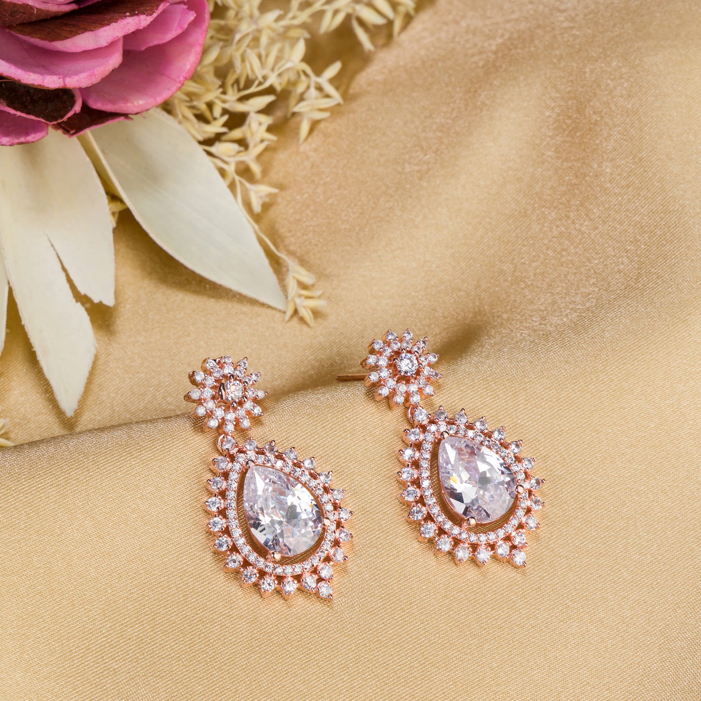 "ROSE GOLD EARRING ADORNED WITH ZIRCON ADDS A TOUCH OF ELEGANCE AND SPARKLE TO ANY EAR."