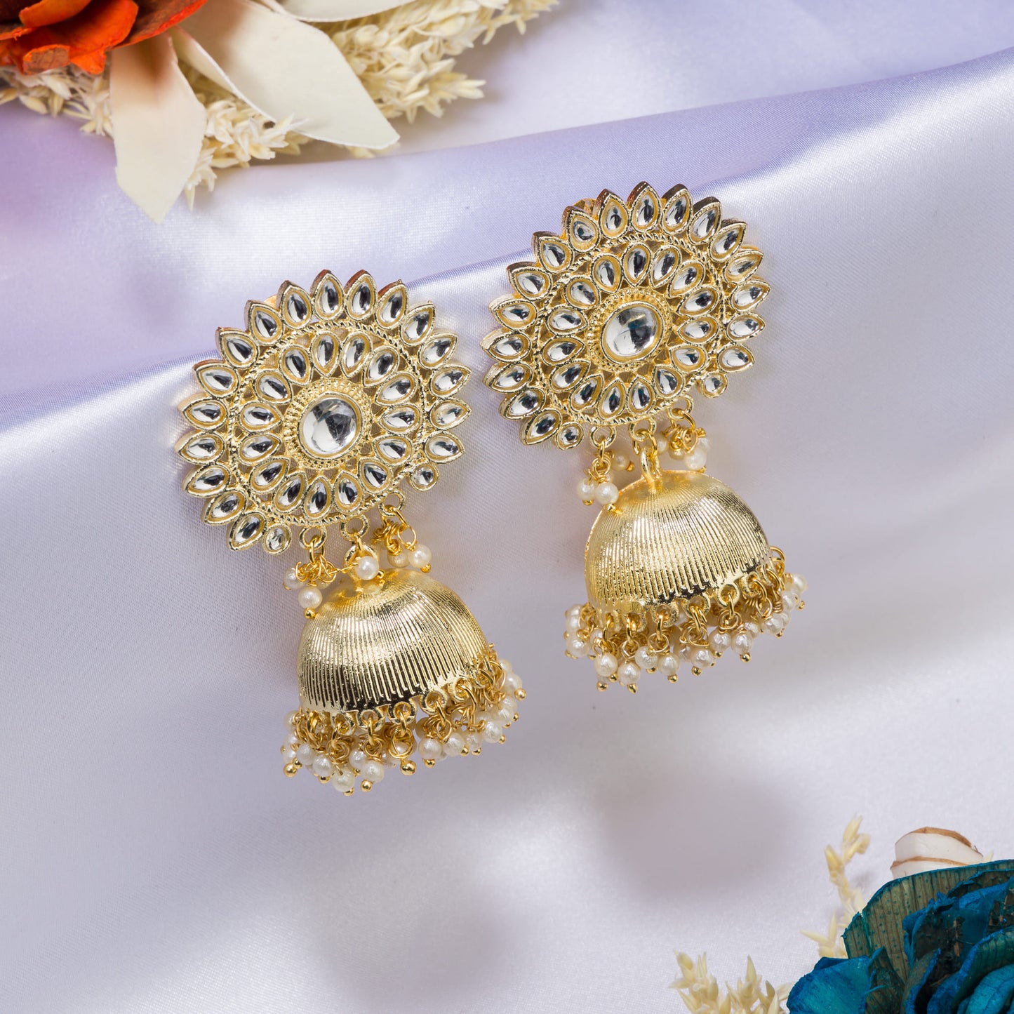 KUNDAN AND PEARLS STUDDED GOLDTONE JHUMKA COMBINES CLASSIC ELEGANCE WITH A TOUCH OF OPULENT SHINE