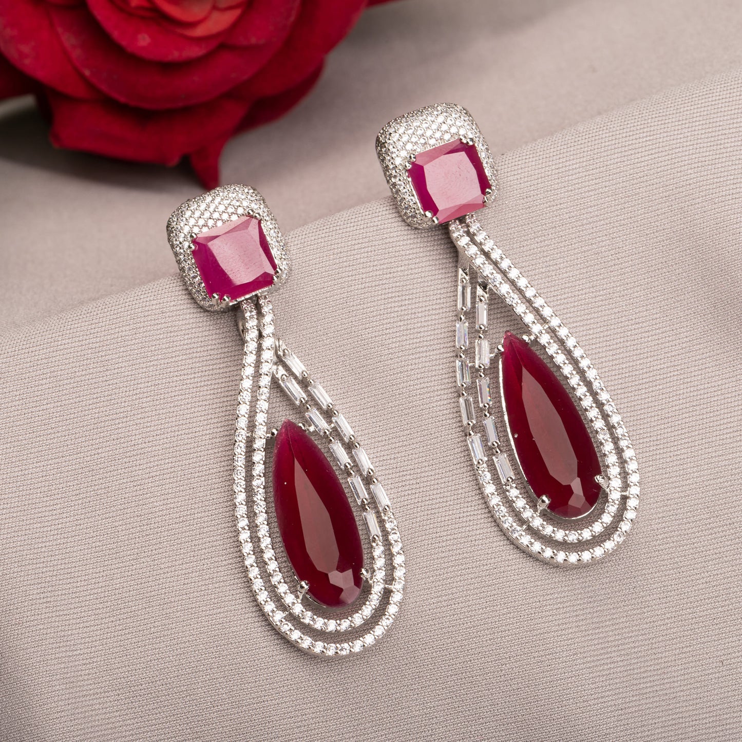 "DARK PINK ZIRCON STUDDED EARRINGS OFFERS A FRESH, DELICATE SPARKLE WITH A HINT OF SERENE ELEGANCE."