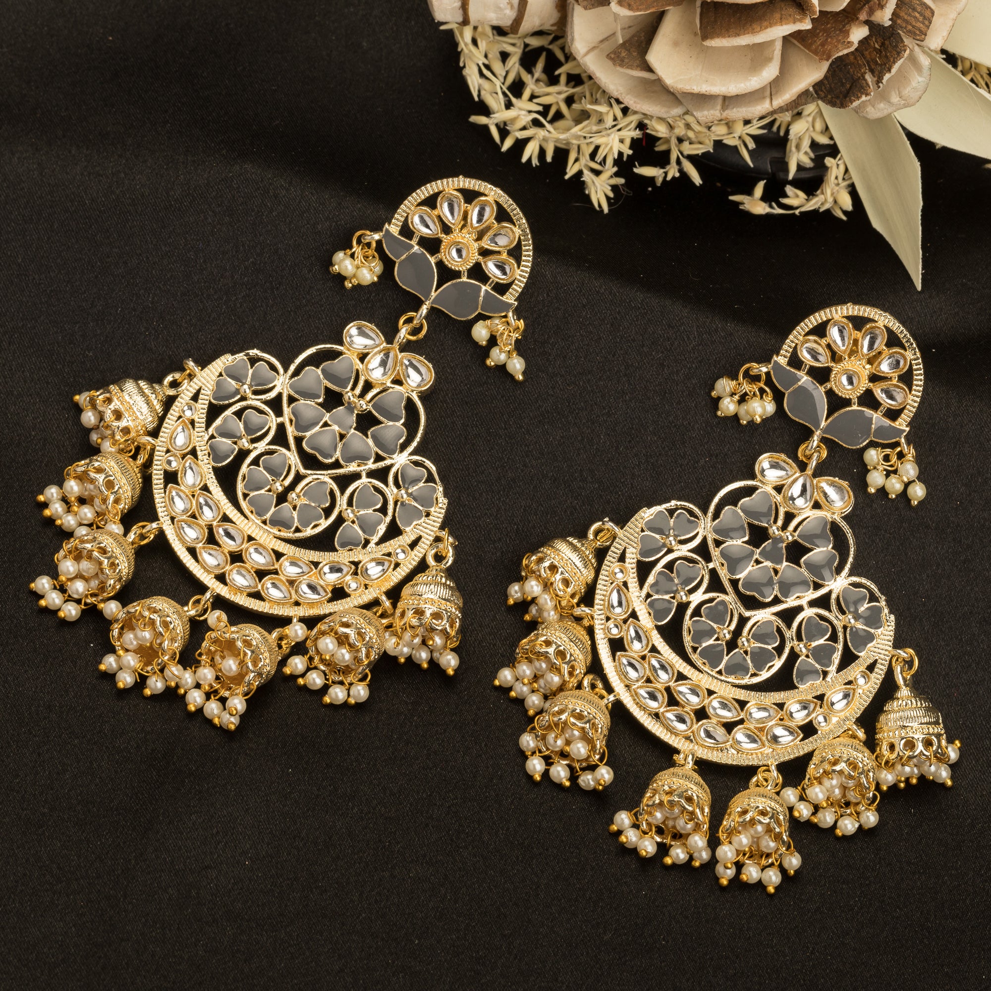 "Kundan earrings with white pearls offer a regal, timeless charm for any occasion."
