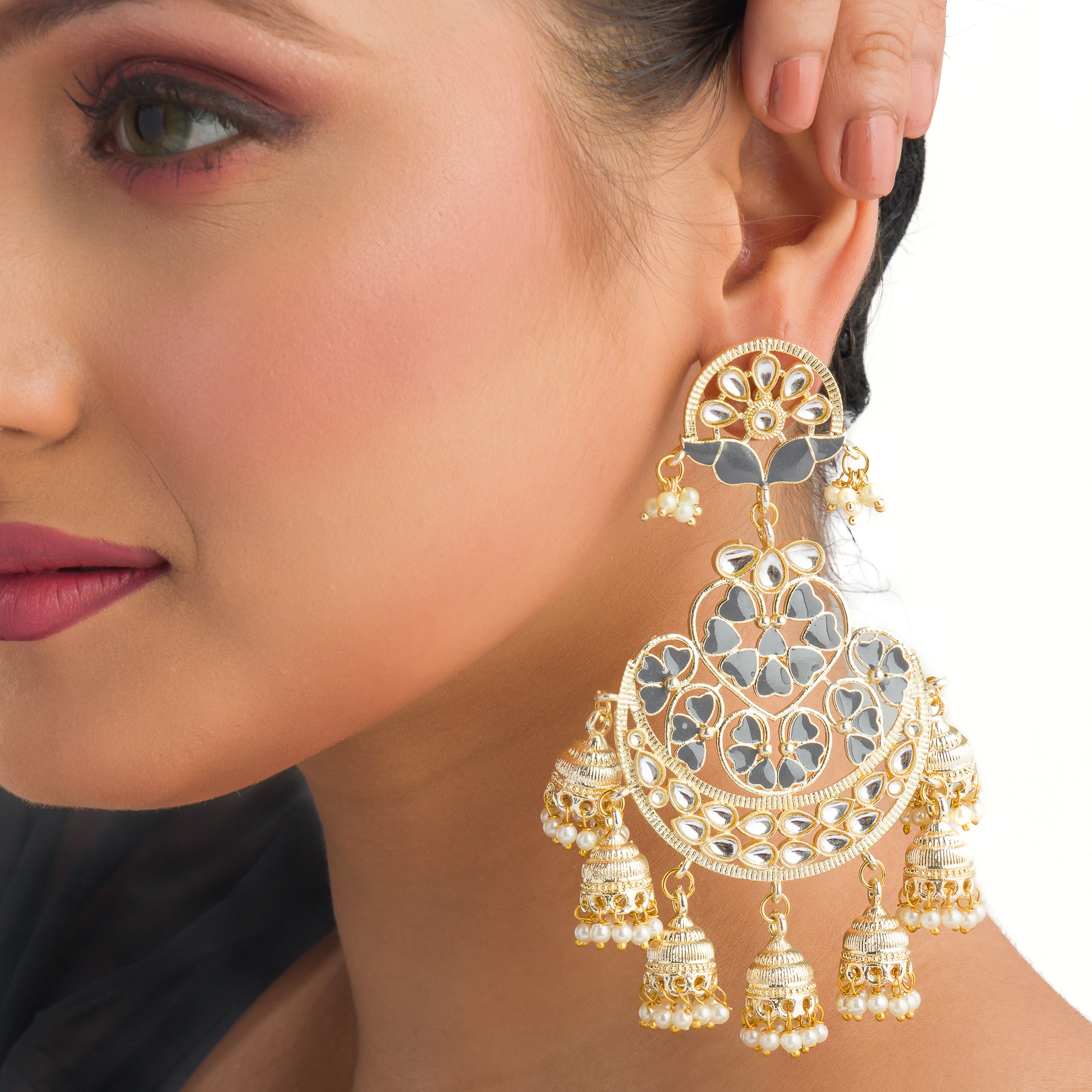 "Kundan earrings with white pearls offer a regal, timeless charm for any occasion."
